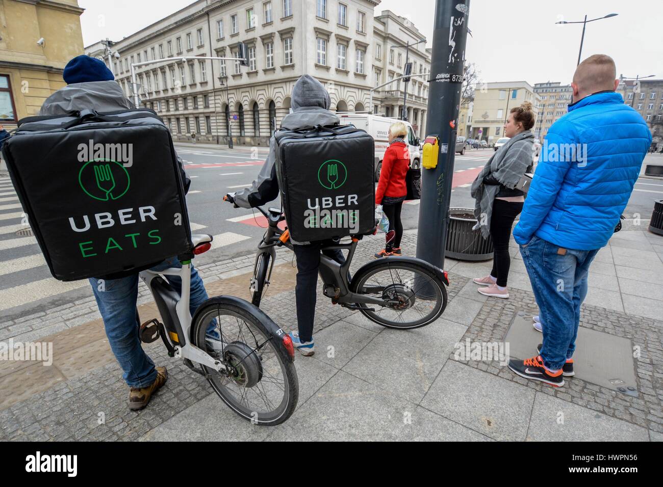 UberEATS delivery men ride through the city centre on March 10, 2017 in