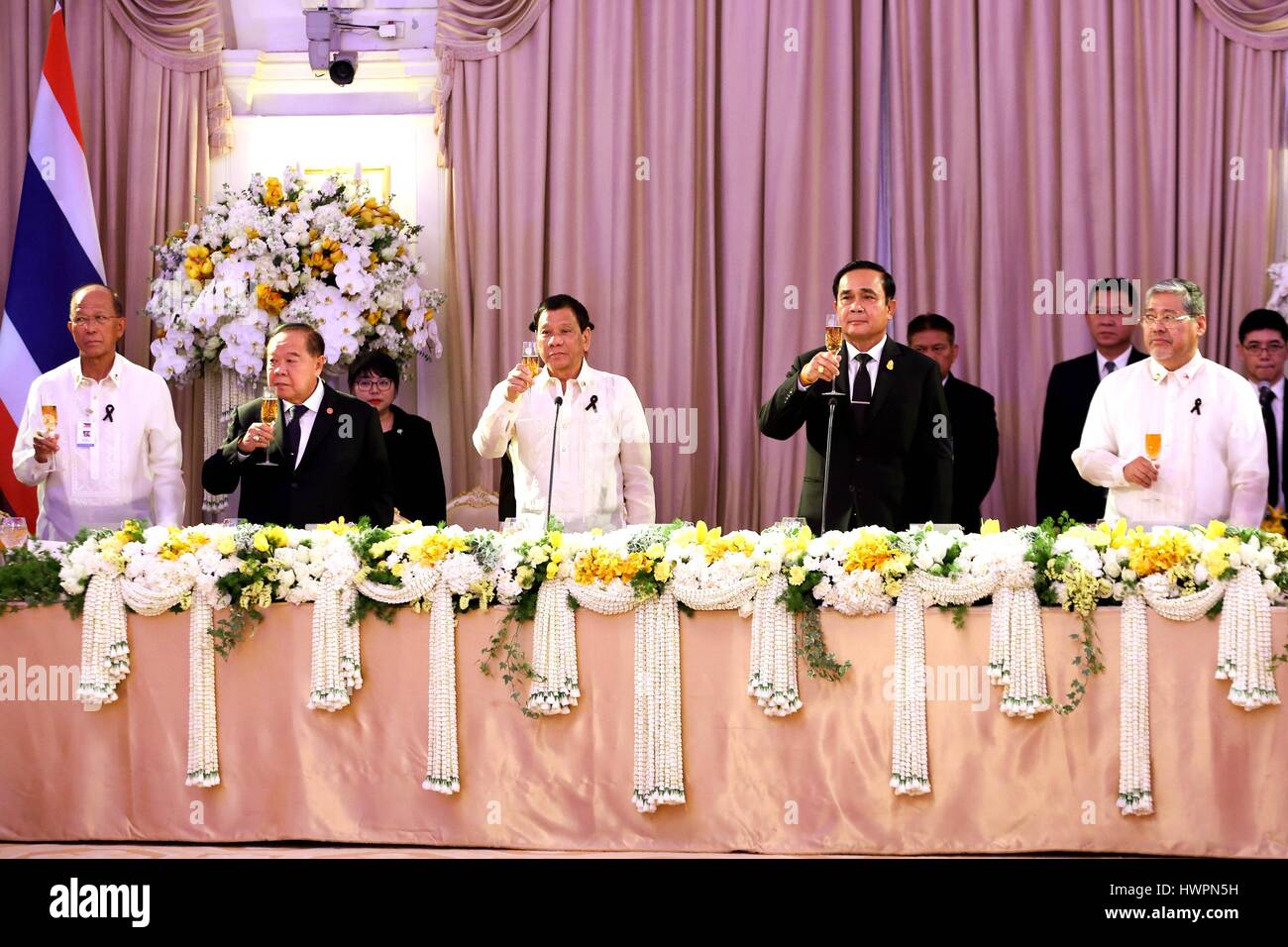 Philippine President Rodrigo Duterte, center, holds his glass in a toast with Thai Prime Minister General Prayut Chan-o-cha during the state dinner at the Government House March 21, 2017 in Bangkok, Thailand. Duterte is in Thailand on a two-day visit. Credit: Planetpix/Alamy Live News Stock Photo