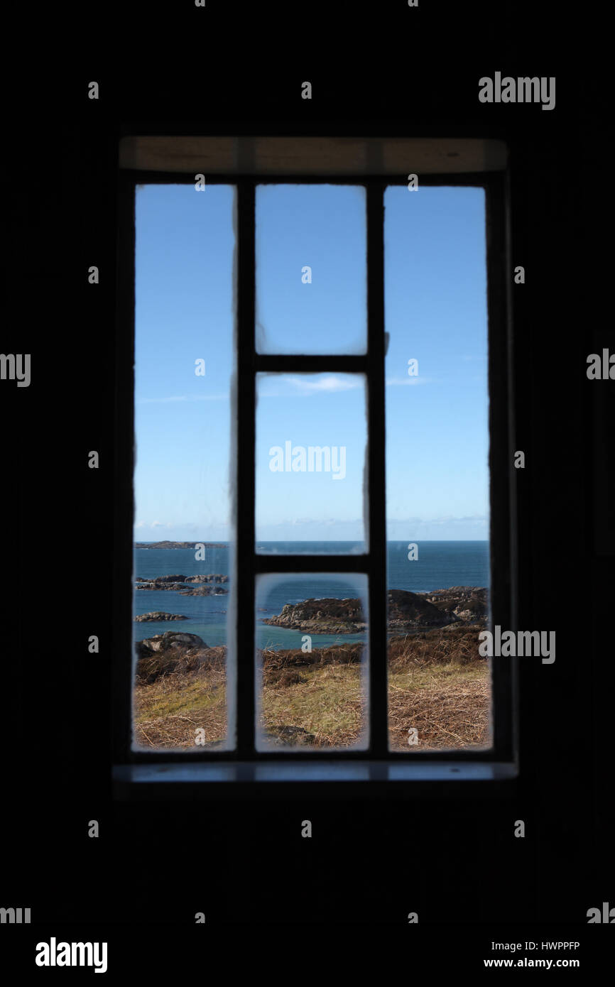 Beautiful clear blue skies seen through one of the windows of the Lighthouse Observatory on the Isle of Erraid. Credit: PictureScotland/Alamy Live News Stock Photo