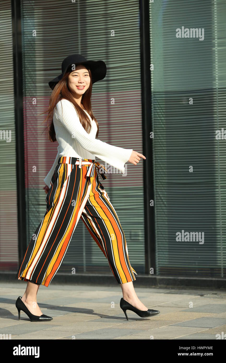 Beijin, Beijin, China. 23rd Mar, 2017. Beijing, CHINA-March 23 2017: (EDITORIAL USE ONLY. CHINA OUT) A chick girl walks along the street in Sanlitun, Beijing's fashion hub, March 23rd, 2017. Credit: SIPA Asia/ZUMA Wire/Alamy Live News Stock Photo