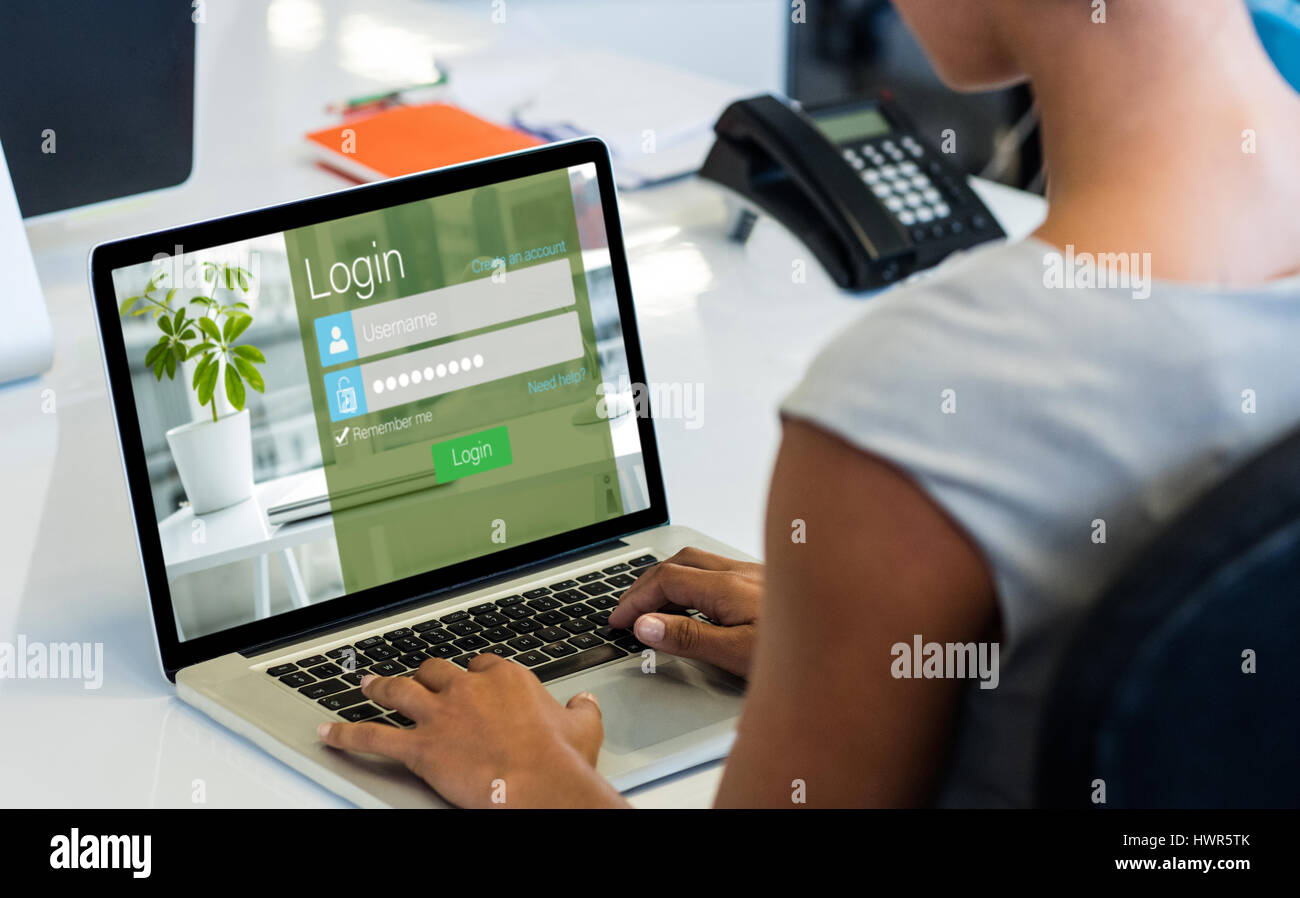 Close-up of login page against woman working on laptop while sitting on ...
