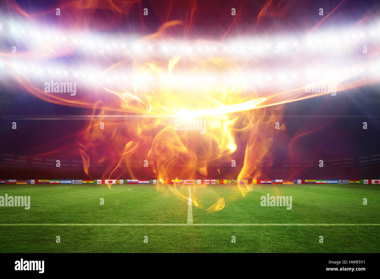 Ball of fire against football pitch under blue lights 3d Stock Photo Alamy