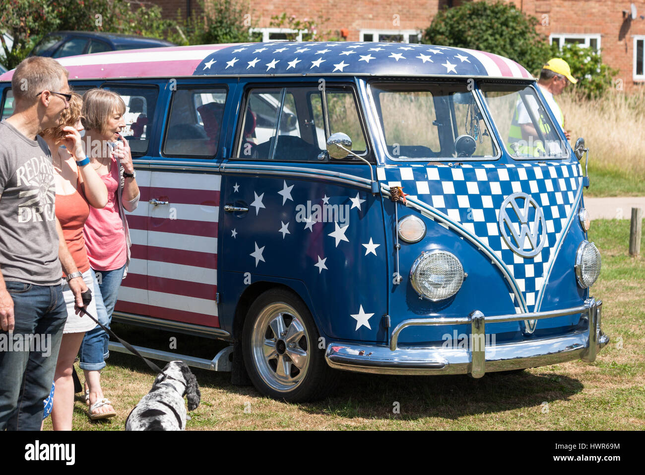VW Beetle camper van painted with the USA flag, dog girl man women looking. kent, uk Stock Photo