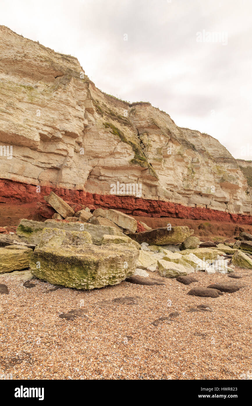 HUNSTANTON, ENGLAND - MARCH 10: Colourful white chalk and red sandstone geological cliff face formation at Hunstanton, Norfolk, England. HDR image. In Stock Photo