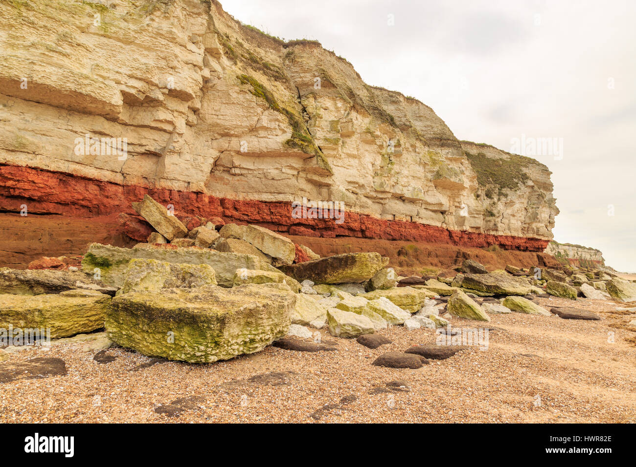 HUNSTANTON, ENGLAND - MARCH 10: Colour contrasting chalk and red sandstone geological cliff face formation at Hunstanton, Norfolk. HDR image. In Hunst Stock Photo