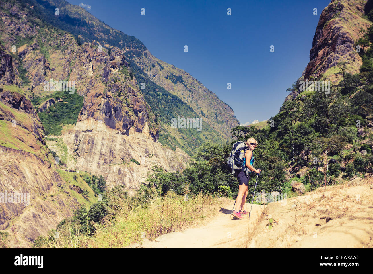 Woman backpacker climbing with backpack in Himalayas, Nepal. Trekking