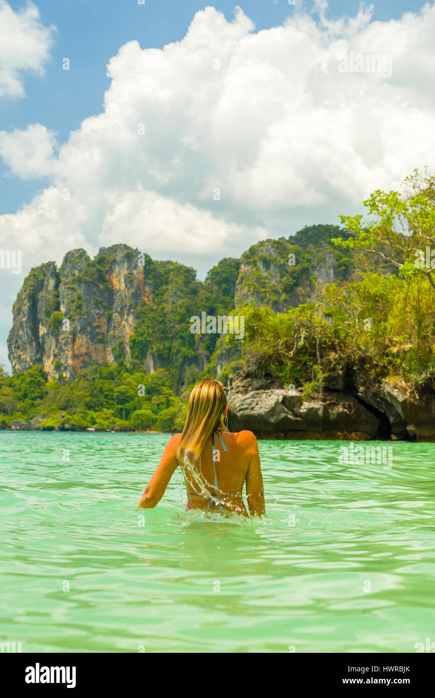 Woman on the Thai beach of Railay in Krabi Thailand Stock Photo