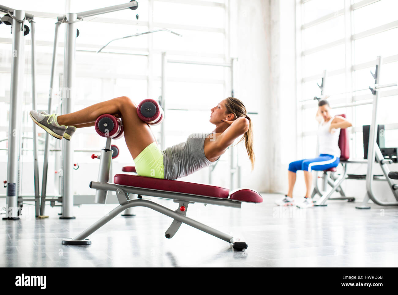 Young woman doing sit-ups in gym Stock Photo - Alamy