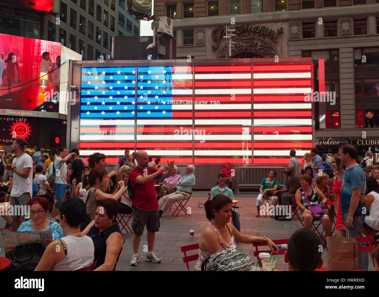 New York City, Usa - July 09, 2015: Tourists in front of an electronic American Flag which adorns the sides of the Armed Forces Recruitment booth in T Stock Photo