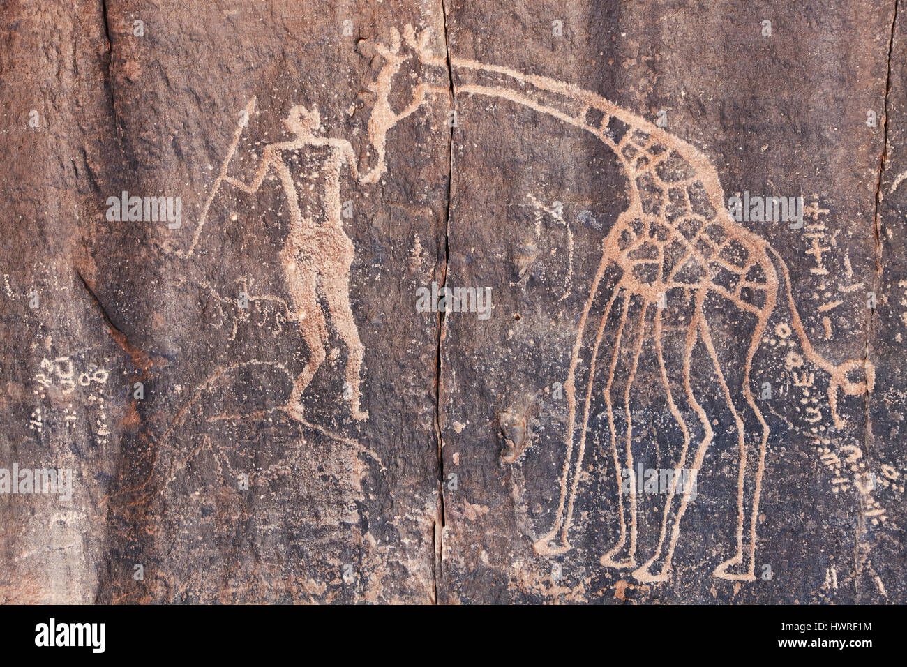 Ancient rock engraving in Sahara Desert, Tadrart, Algeria Stock Photo