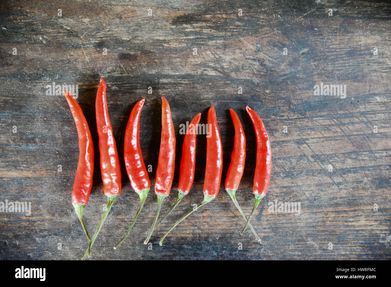 red hot chilli peppers on wooden background Stock Photo - Alamy