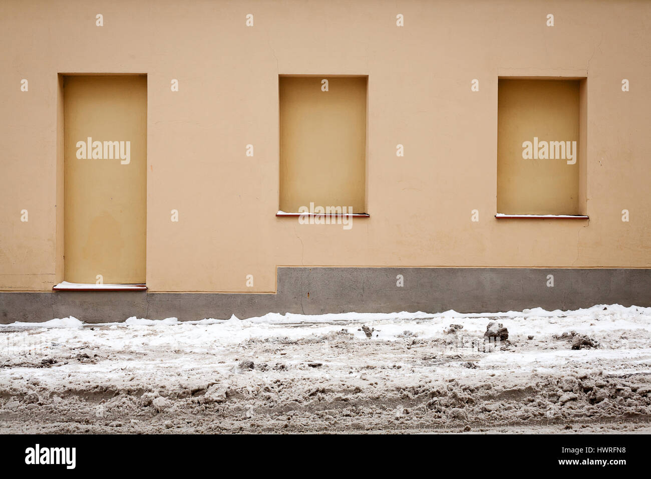 Immured Yellow wall with immured door and windows in winter Stock Photo - Alamy
