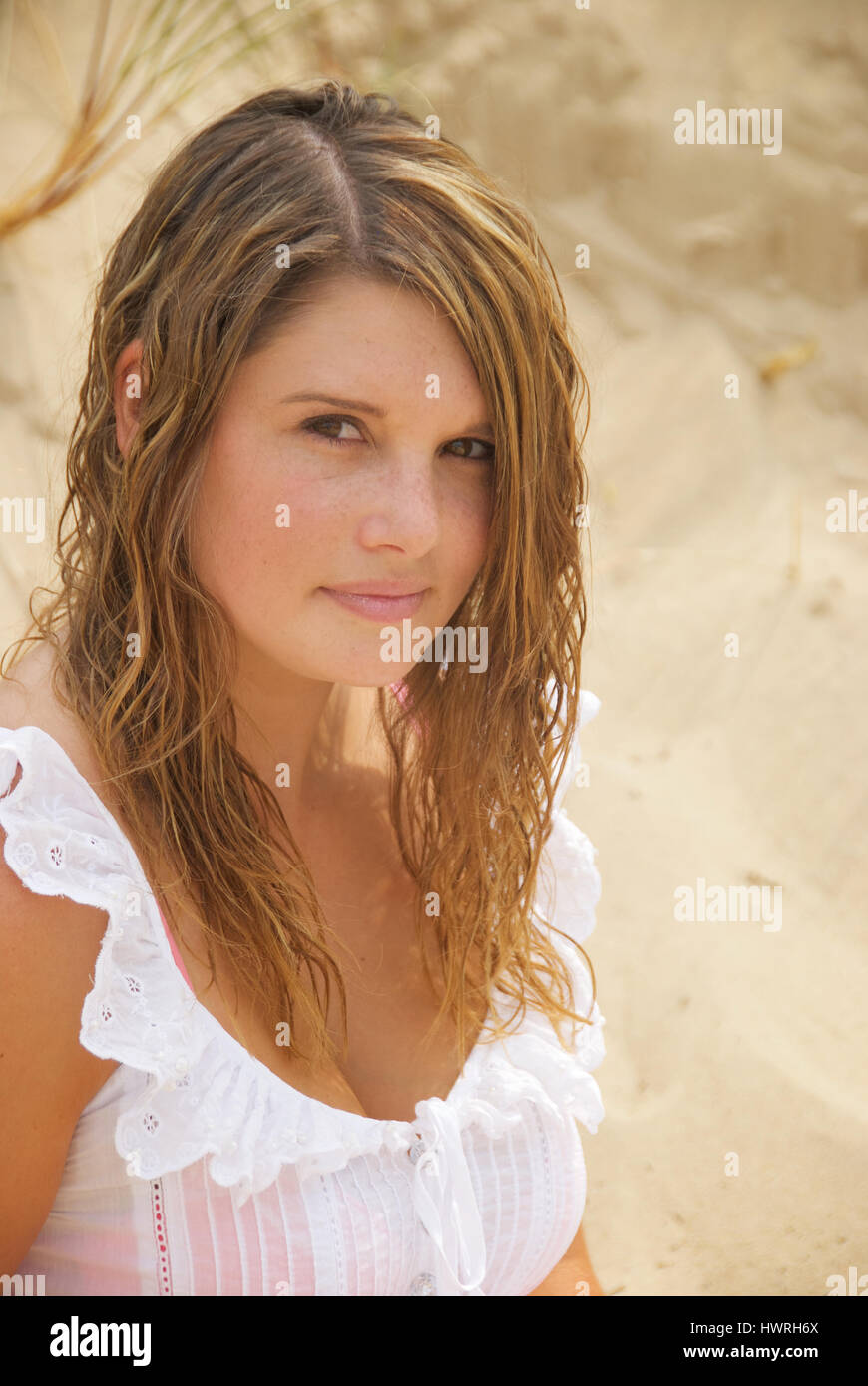 Beautiful young woman on the beach wearing a white summer dress Stock ...