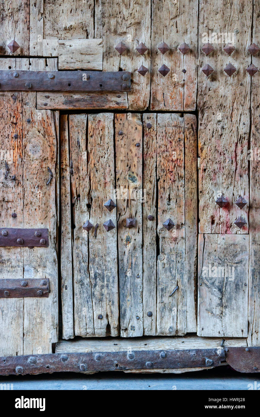 Old weathered wooden gate of Torres de Serranos with wicket gate. Valencia, Spain. Stock Photo