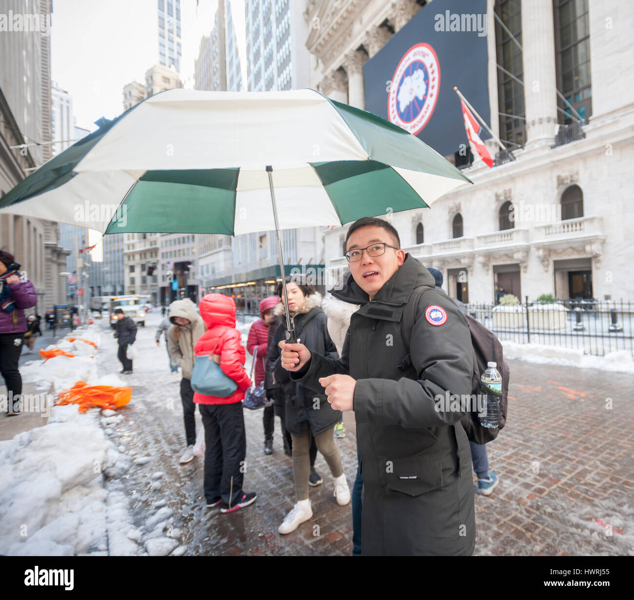 A tour guide wears his Canada Goose parka outside the New York Stock  Exchange during the Canada Goose IPO debut on Thursday, March 16, 2017. The  Canadian parka maker Canada Goose Holdings