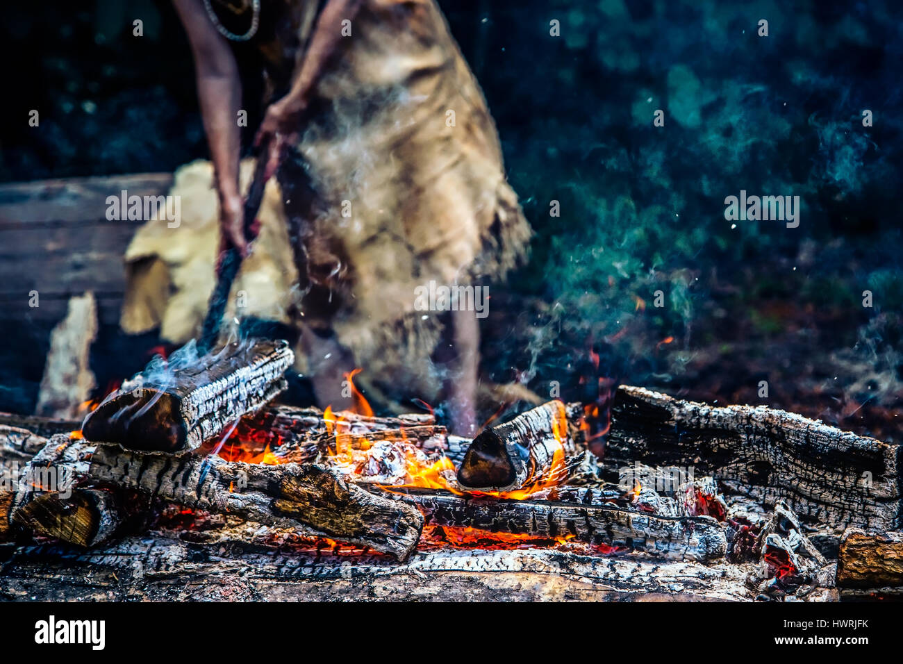 A bed of hot coals with a  Native American woman in the background. Stock Photo