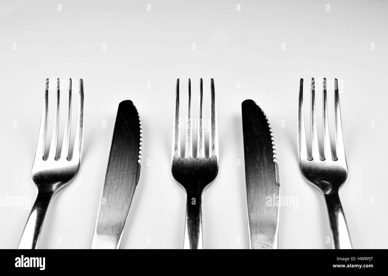 Forks and Knives isolated on bright background Stock Photo