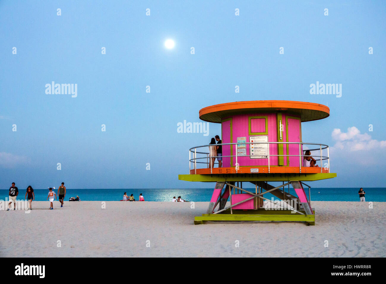 Miami Beach Florida,South Beach,Atlantic Ocean,sand,lifeguard station,moon,reflection on water,twilight,couple,round structure,FL170209020 Stock Photo