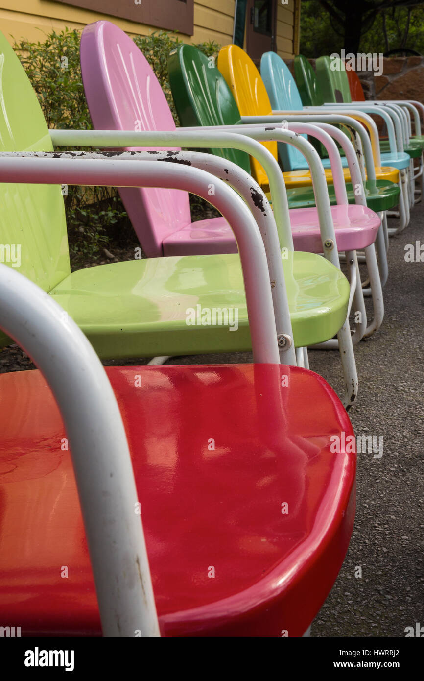 A Close Up Shot Of A Row Of Colorful Vintage Metal Lawn Chairs In