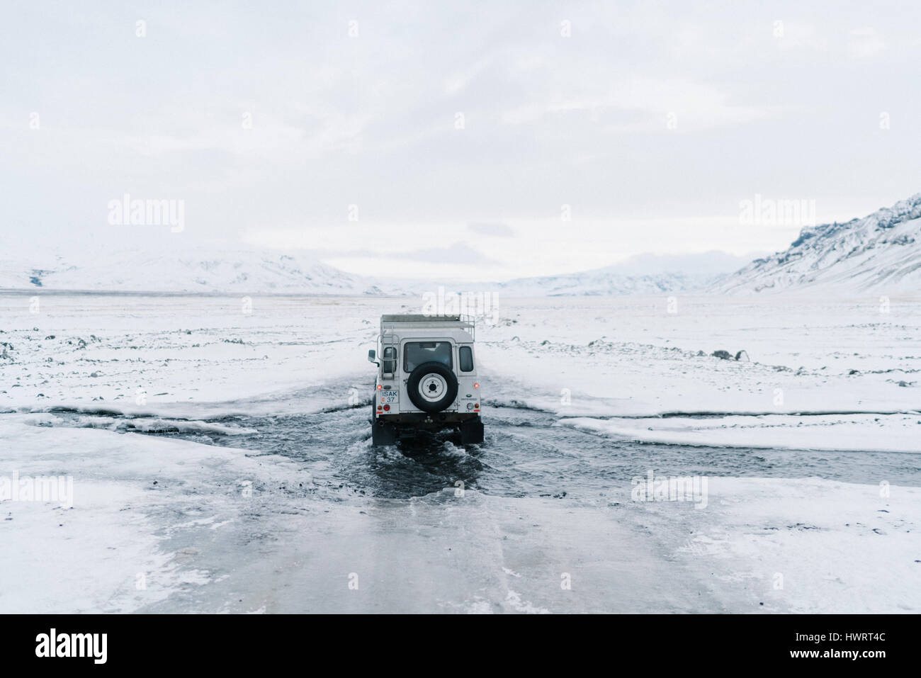 Land Rover driving off road through rugged Icelandic landscape. Stock Photo