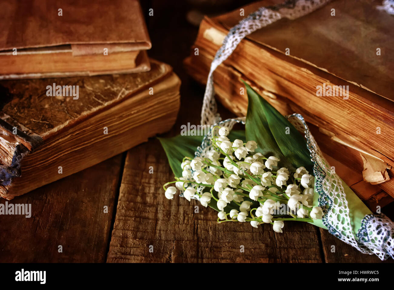 bouquet lilies and retro book Stock Photo Alamy