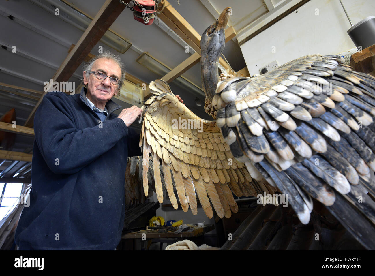 Artist Nick Johnson in his Lewes workshop with two giant sculptures of vultures Stock Photo
