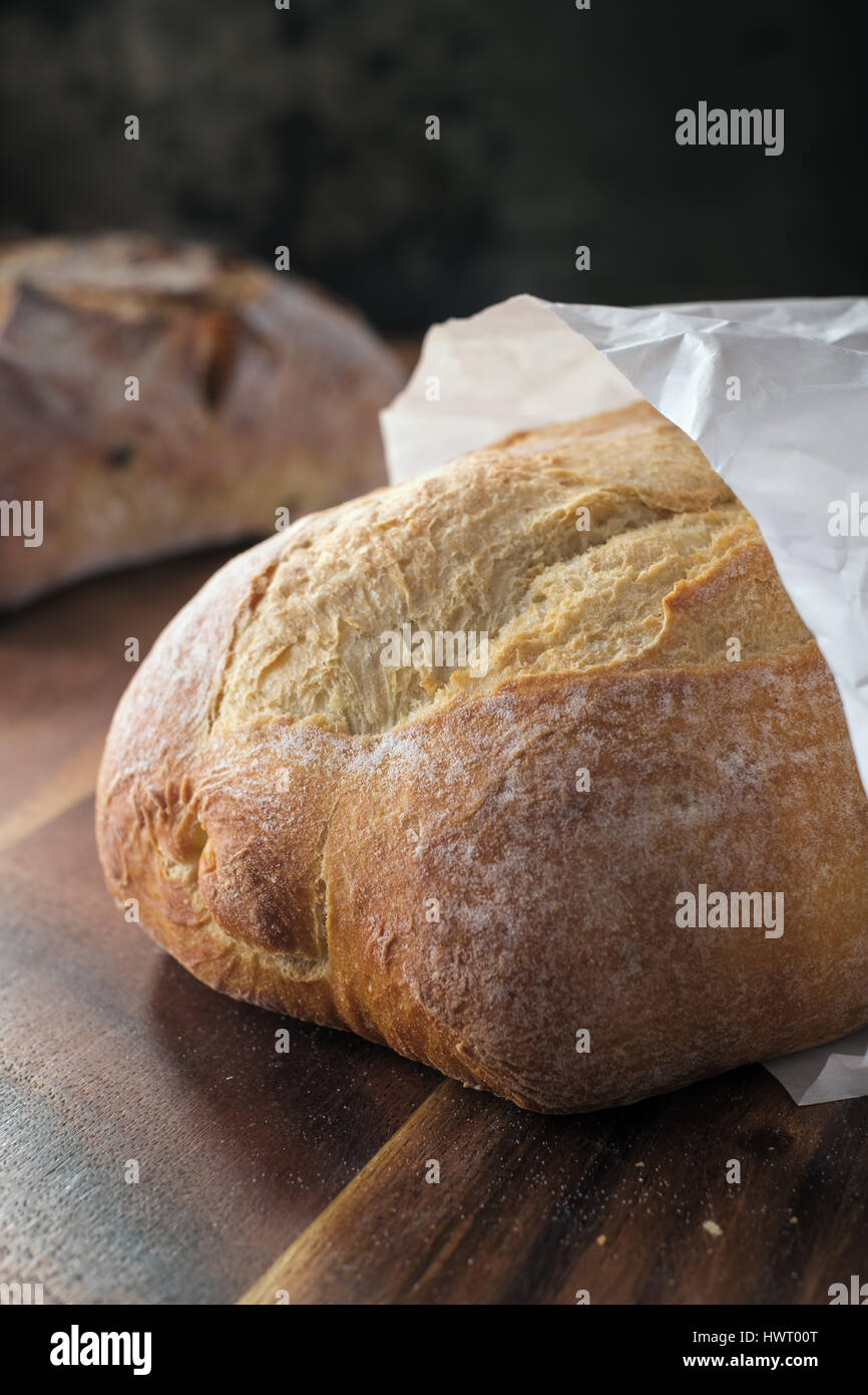 Loaf of wheat bread in paper bag Stock Photo