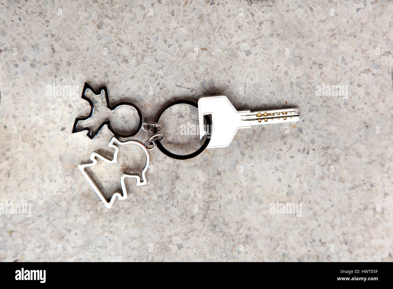 Keyring with a male and female shapes representing couples moving together. Stock Photo