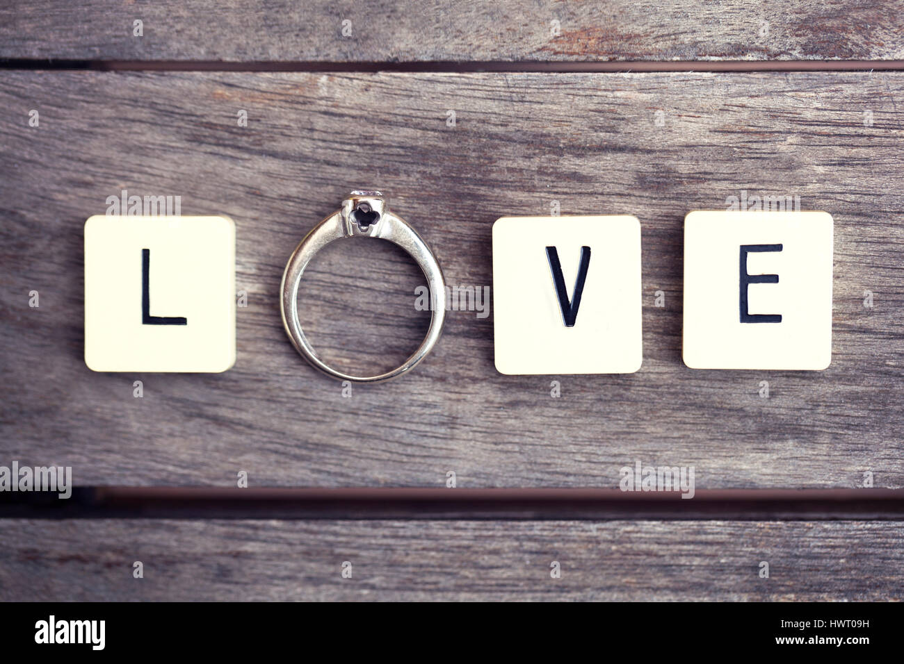 Letter tiles and ring spelling the word 'LOVE'. Conceptual picture for love, wedding, mariage, engagement, etc... Stock Photo