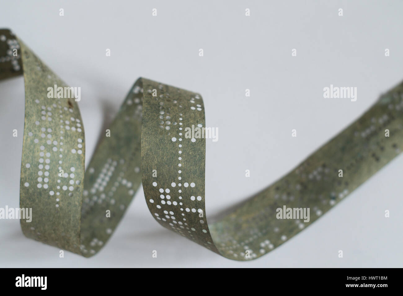 Strips of old punched tape on white surface Stock Photo Alamy
