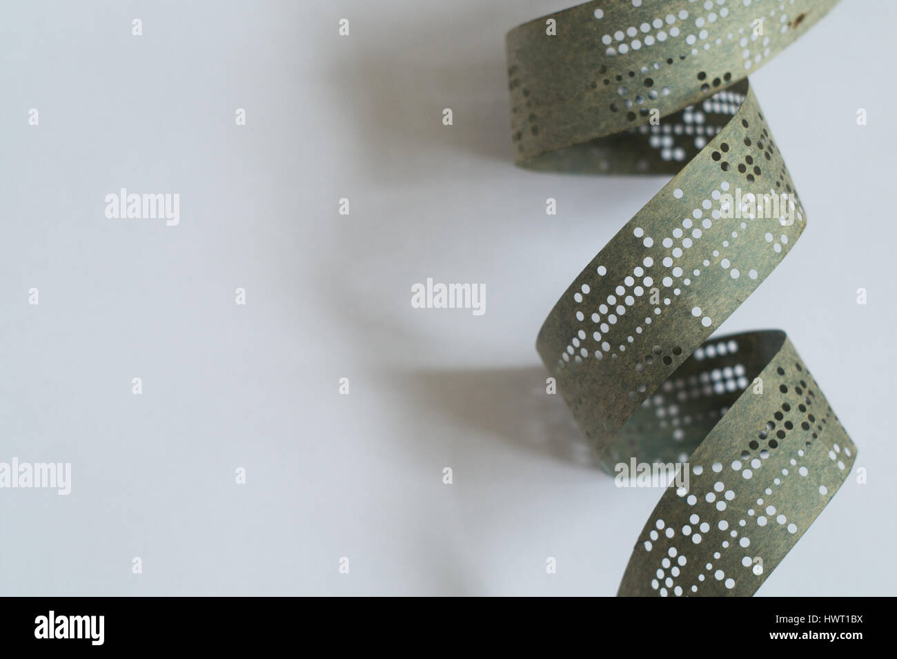 Strips of old punched tape on white surface Stock Photo Alamy