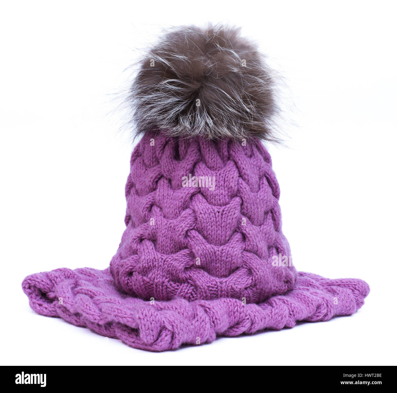 Violet knitted woolen scarf and hat with pompom isolated on white background Stock Photo