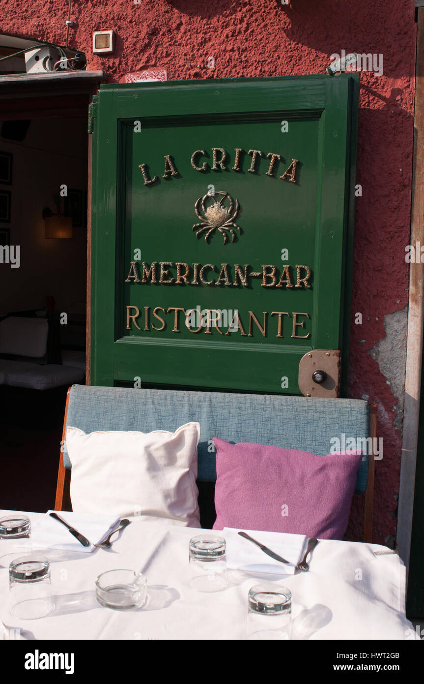 Portofino: cushions and table outside La Gritta American bar, famous restaurant since 1954 meeting place for the international jet-set and royals Stock Photo