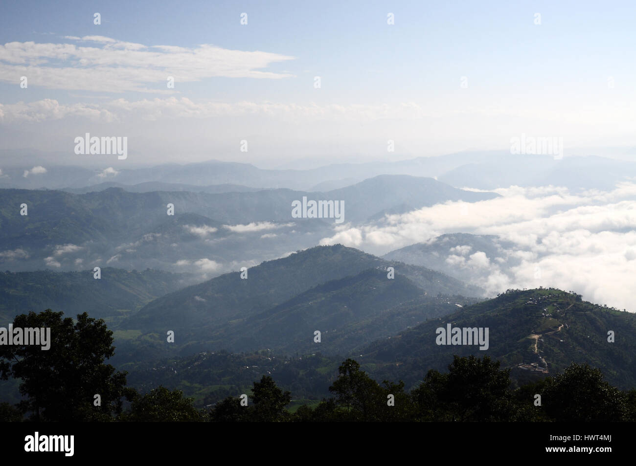 Foggy cloudy morning in Nepalese Himalayas mountains - top view from Nagarkot hotel Stock Photo
