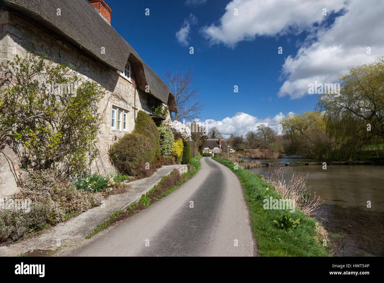 Thatched cottages near the pond in the pretty village of Sherrington, Wiltshire, England, UK Stock Photo