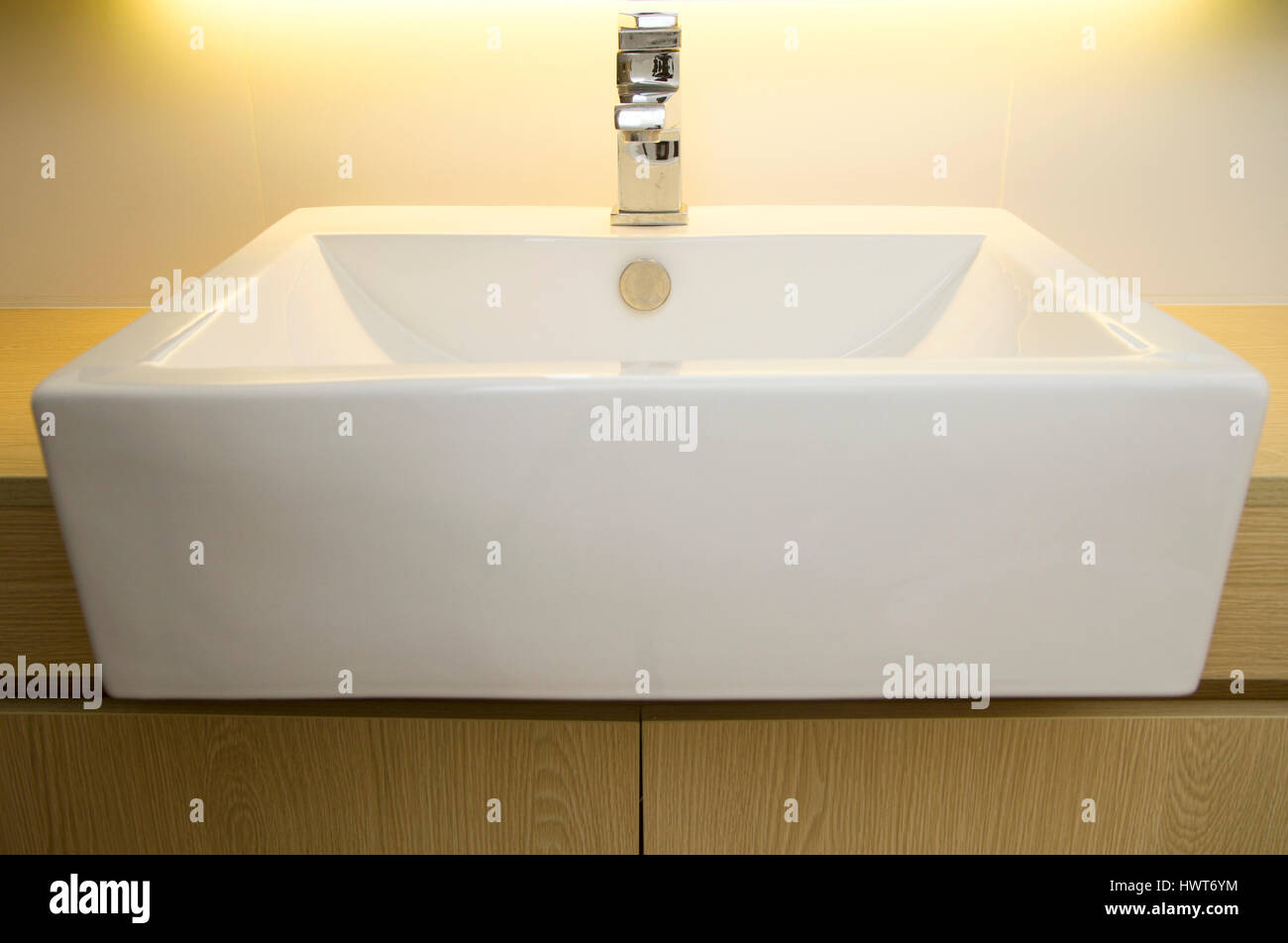 Close Up Of A Modern Stainless Steel Faucet On White Porcelain