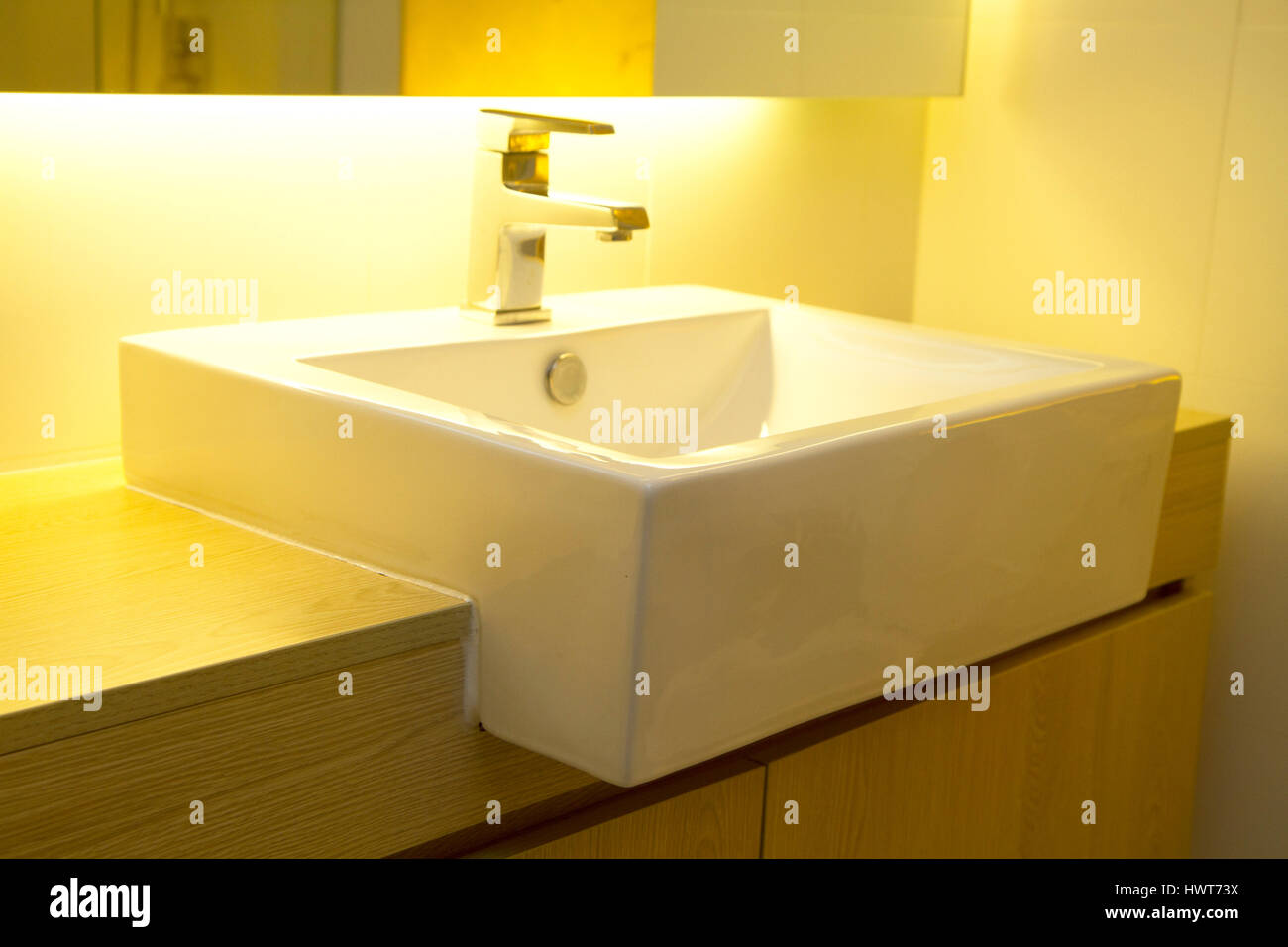 Close Up Of A Modern Stainless Steel Faucet On White Porcelain