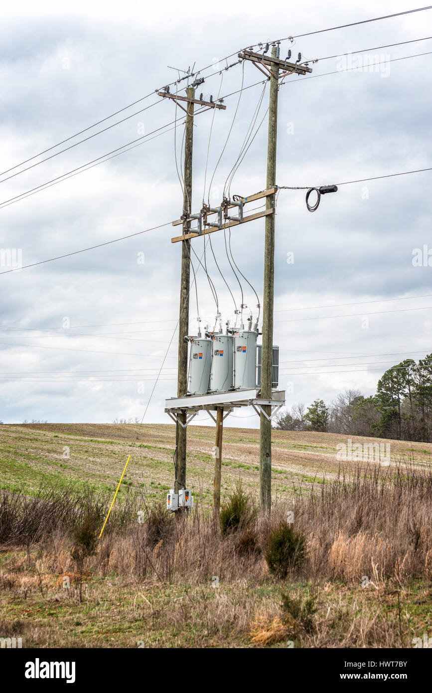 Three Electric Utility Transformers On Telephone Poles Stock Photo