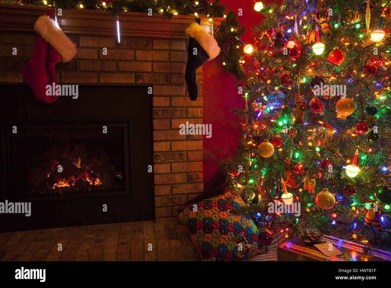 Christmas fireplace with stockings and Christmas tree and gifts Stock