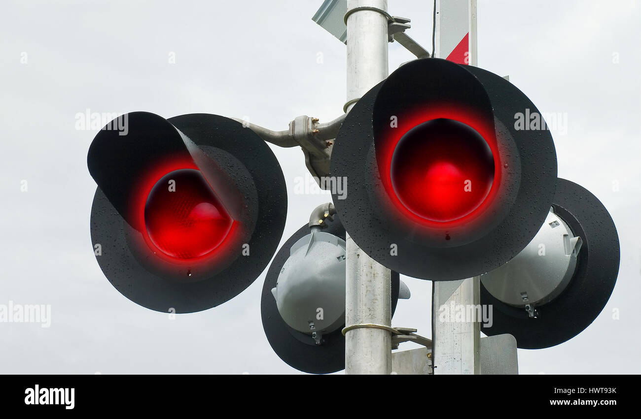 Flashing lights of track and road signals Stock Photo