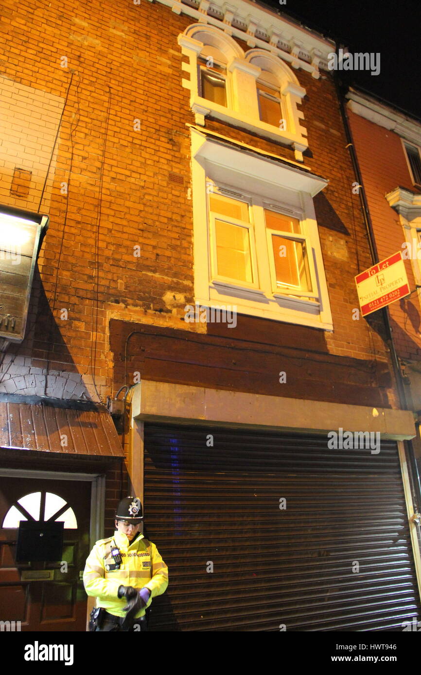 A police officer stand outside an address in Hagley Road, Birmingham, where armed police have raided a flat overnight. West Midlands Police have directed media queries to the Met Police, who have refused to discuss the incident for operational reasons. Stock Photo
