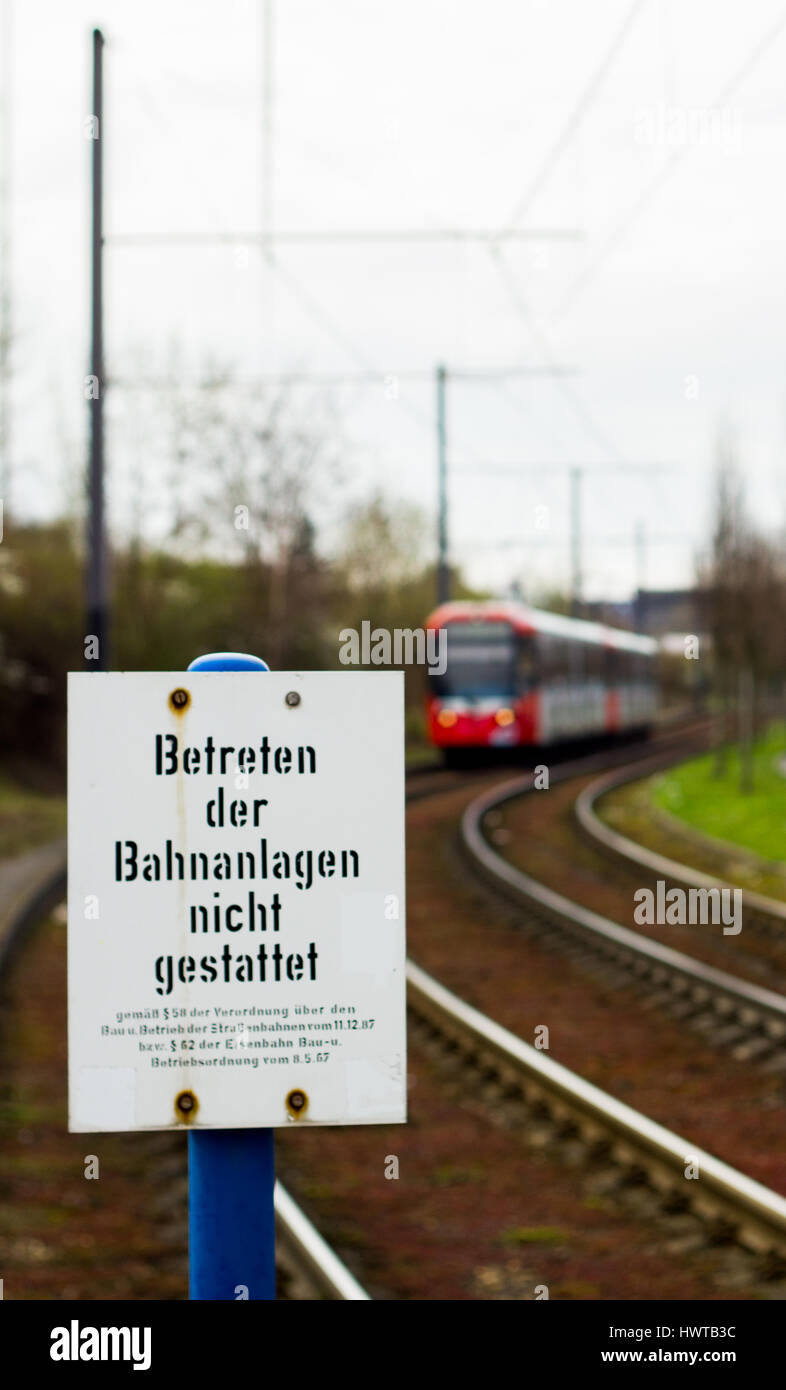 A passenger tram approaches from the distance set among suburban Cologne, Germany Stock Photo
