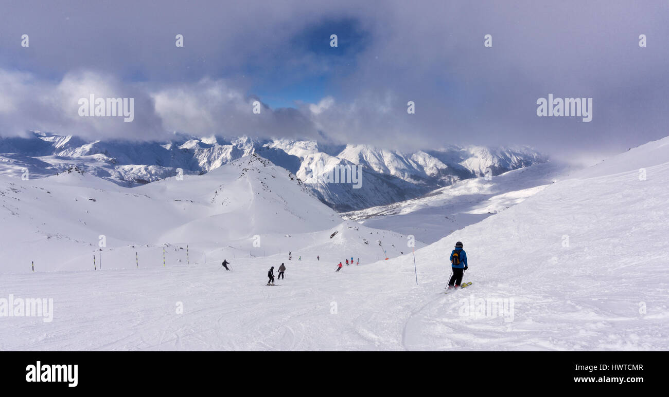 Panorama of skiers under low cloud at Les Menuires in the Three Valleys ski area of France Stock Photo