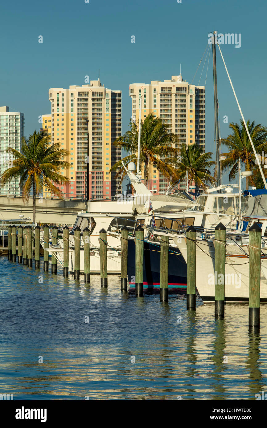 Boats moored in the Fort Myers Yacht Basin with condominium towers beyond, Ft Myers, Florida, USA Stock Photo
