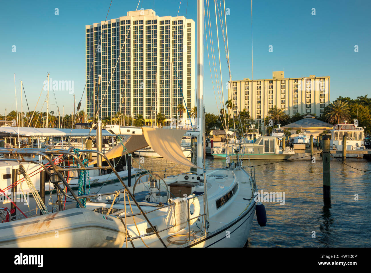 Boats moored in the Fort Myers Yacht Basin with condominium towers beyond, Ft Myers, Florida, USA Stock Photo