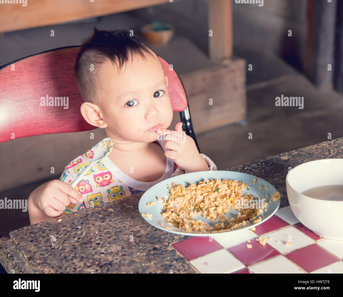 Asian baby eating fried rice  by self, Baby from Thailand Stock Photo