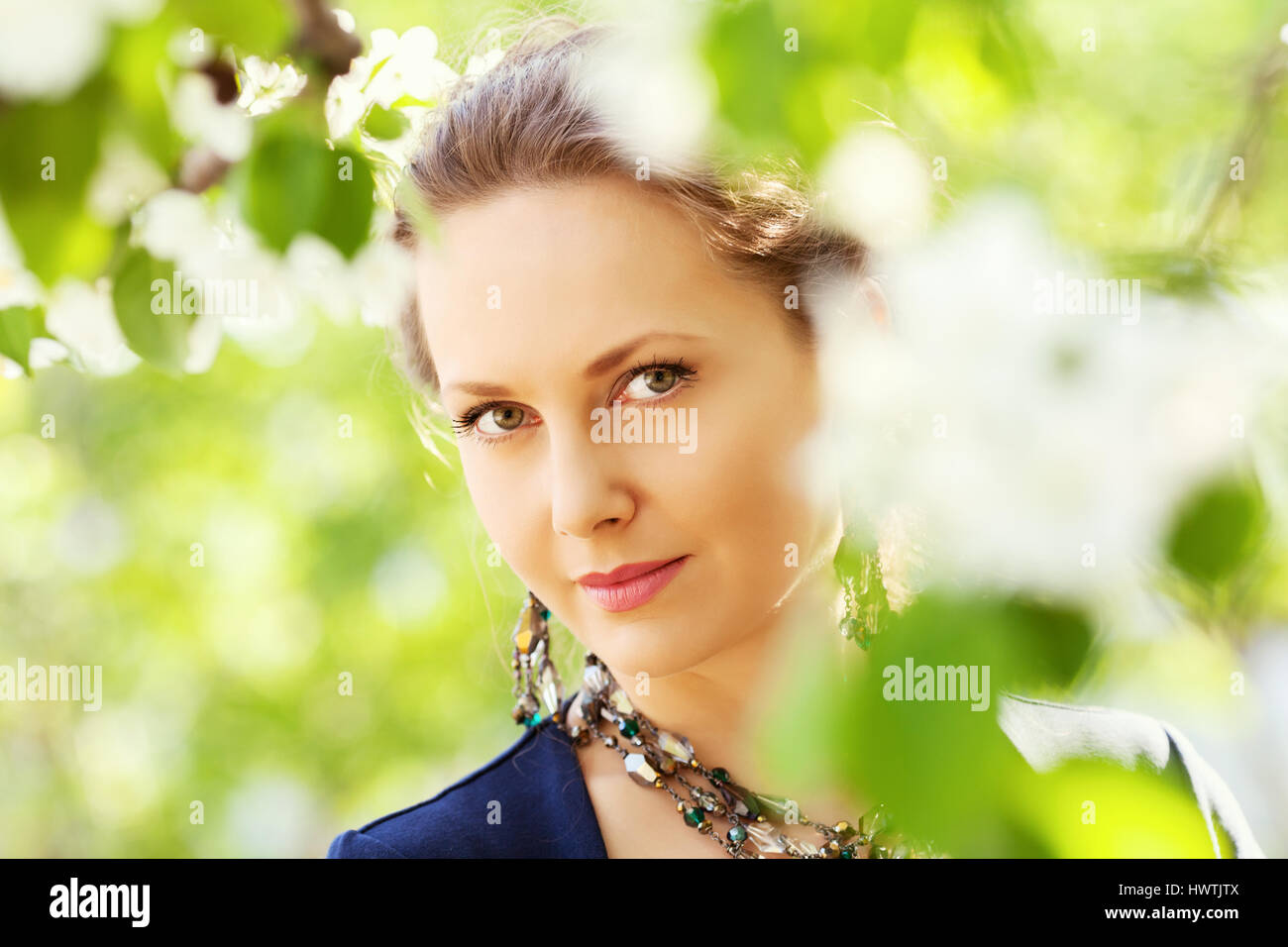 Beautiful woman in a spring garden Stock Photo - Alamy