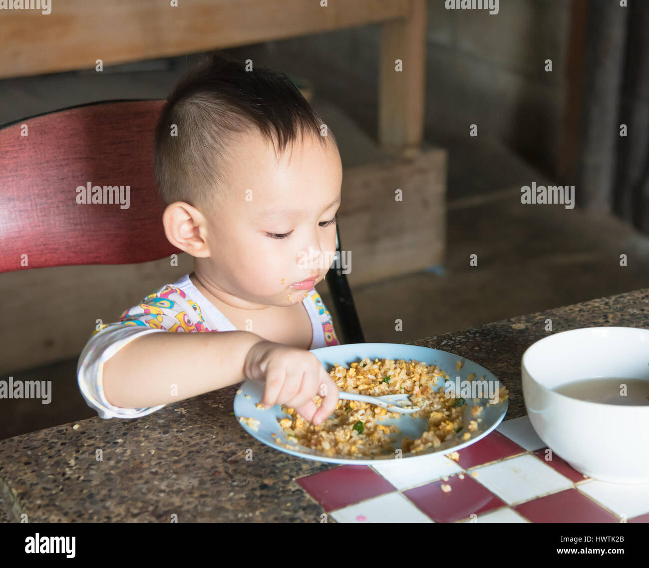 Asian baby eating fried rice  by self, Baby from Thailand Stock Photo