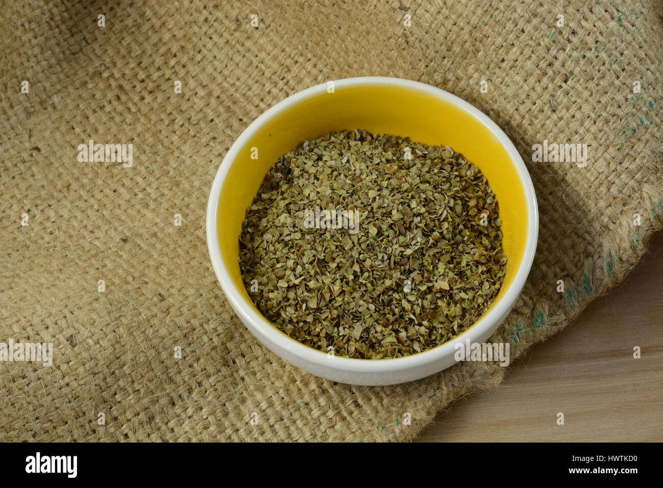 Marjoram leaves herb is small spice dish on burlap Stock Photo Alamy