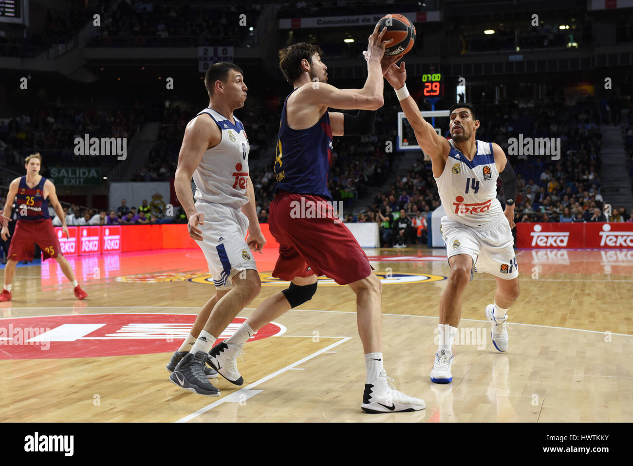 Madrid, Spain. 22nd Mar, 2017. Ante Tomic, center #44 of FC Barcelona Lassa in action with Gustavo Ayón, right, #14 of Real Madrid, and Jonas Maciulis #8 of Real Madrid, during the Euroleague basketball match between Real Madrid and FC Barcelona Lassa in WiZink center in Madrid. Credit: Jorge Sanz/Pacific Press/Alamy Live News Stock Photo